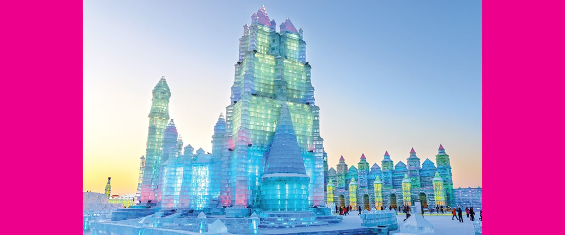 Image of a huge frozen castle lit up by lights