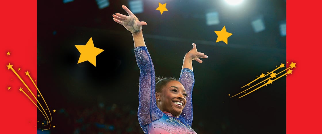 Image of a proud Simone Biles performing