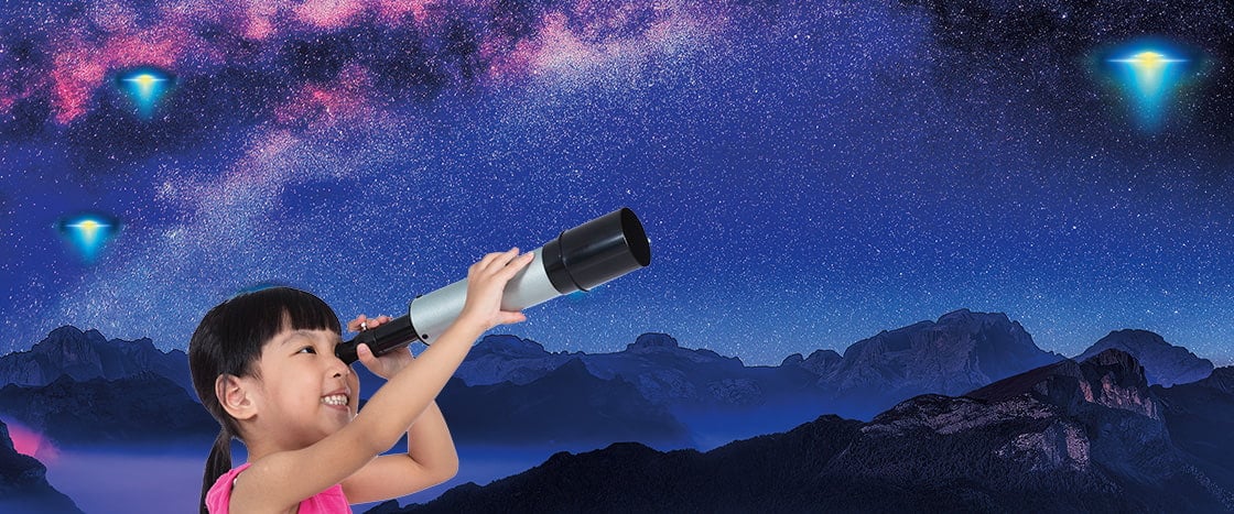 Image of kid looking at night sky with telescope