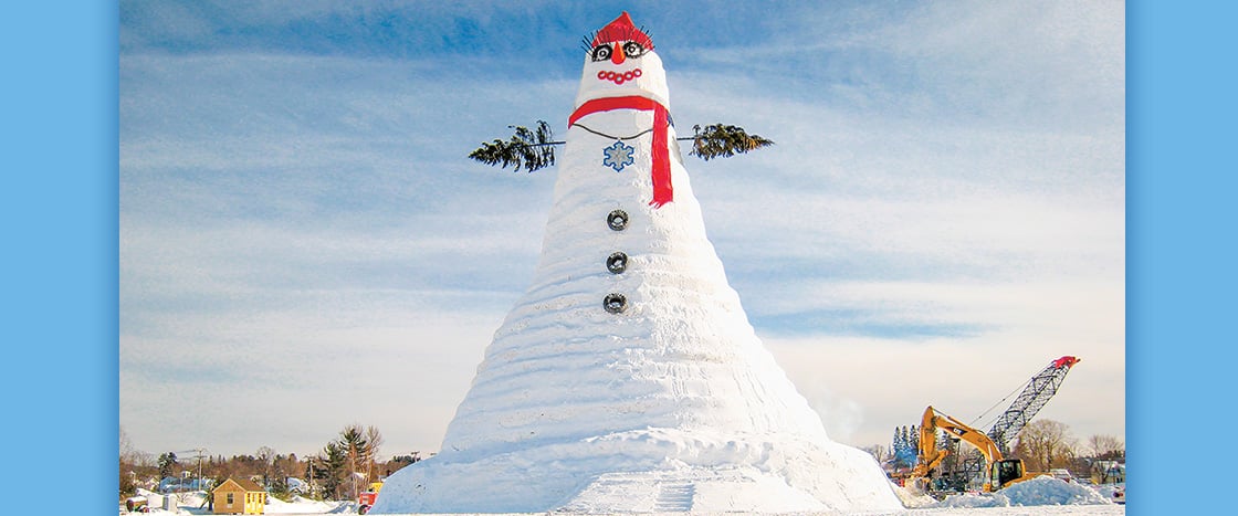 Image of world&apos;s tallest snowperson with wreath eyes and red tire mouths